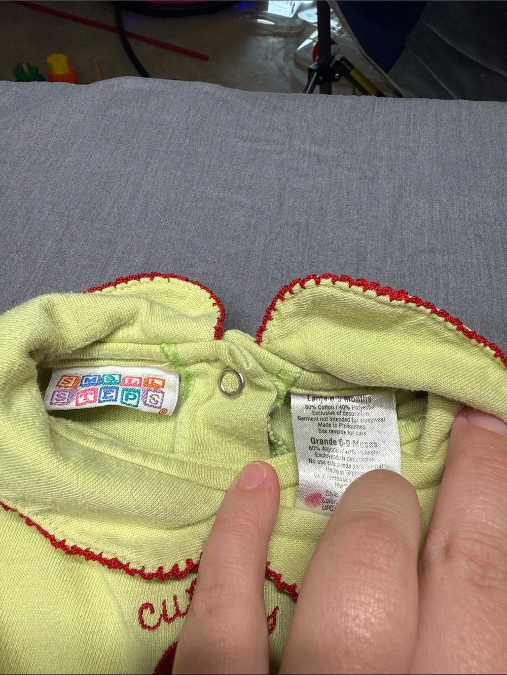 Vintage small steps Green Baby Onesie with Red Trim and Button Motif